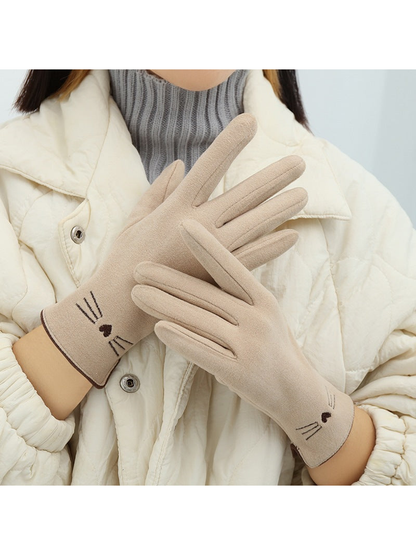 Ivory cat-motif gloves worn in a crossed-hand view