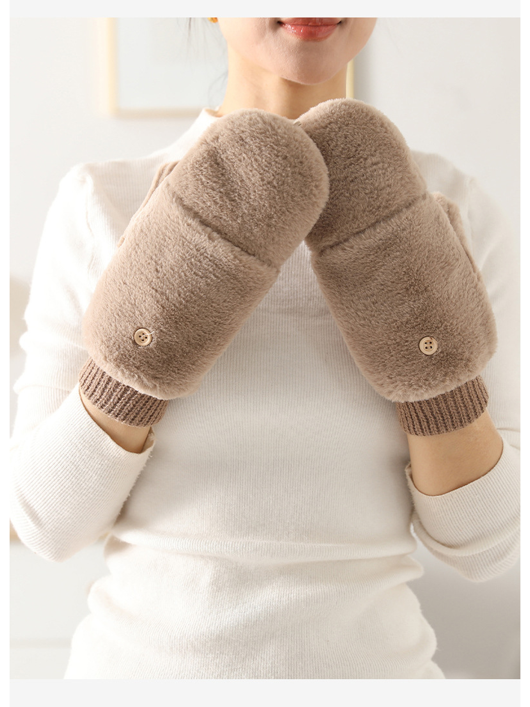 Beige fuzzy mittens worn with the fold-back covers closed