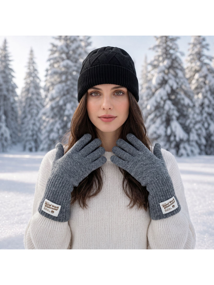 Gray knit gloves worn with a black beanie in a snowy setting
