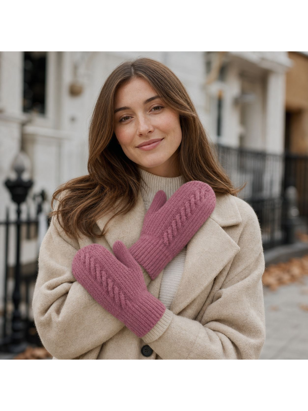 Dusty Pink cable-knit mittens worn with a cream coat outdoors