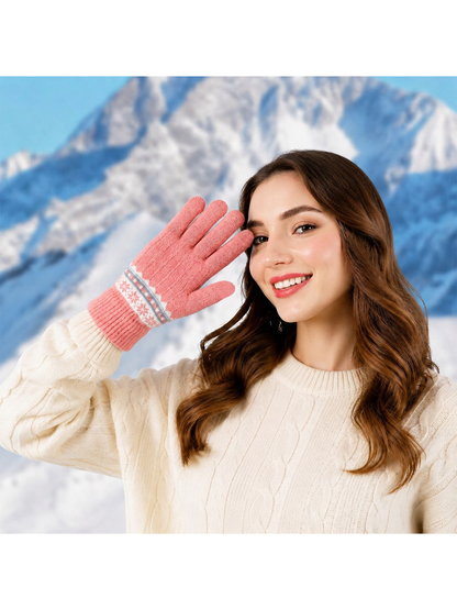 Pink patterned glove worn in a snowy mountain setting