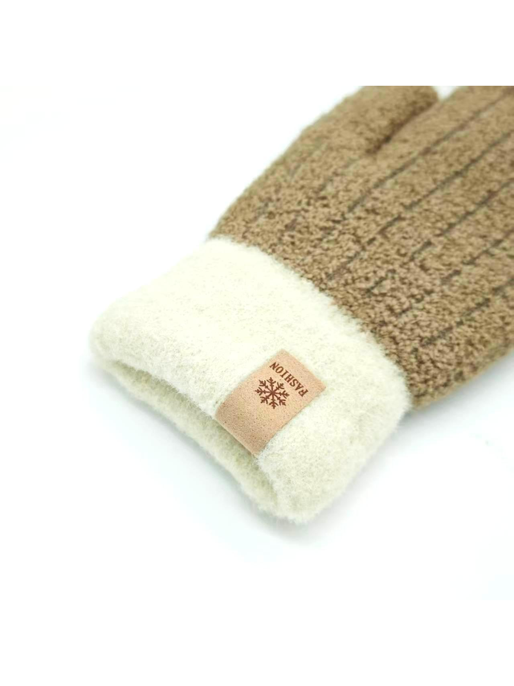 Close-up of a brown mitten's cream folded cuff and snowflake label