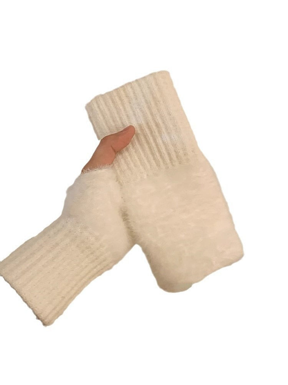 White fuzzy fingerless gloves with extended ribbed cuffs on a plain background