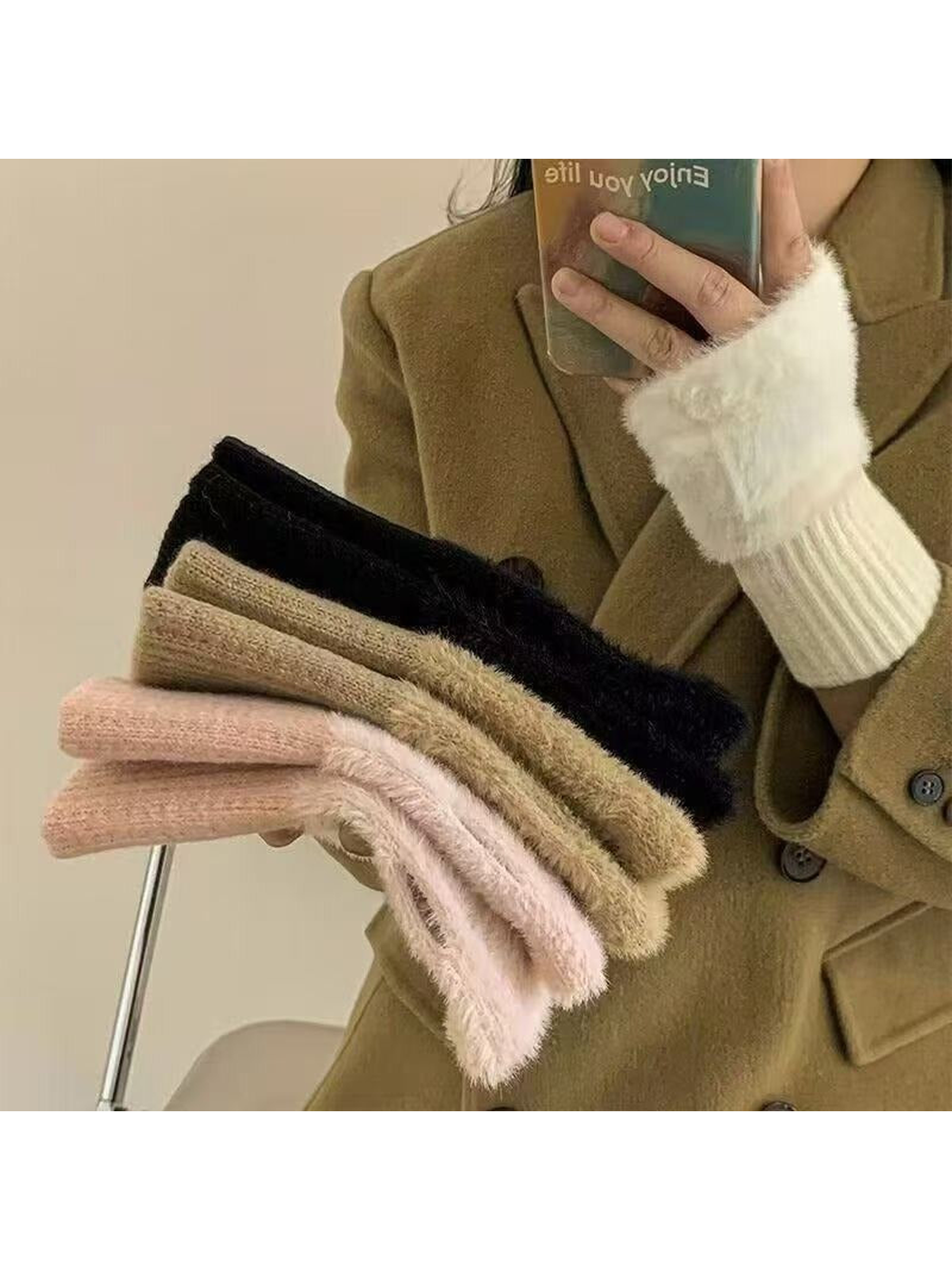 White, khaki, pink, and black fuzzy fingerless gloves displayed together