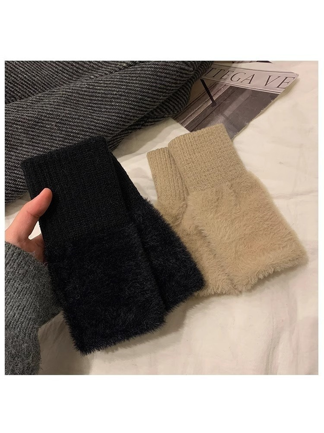 Black and khaki fuzzy fingerless gloves arranged in a flat lay