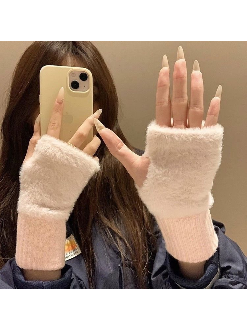 Pink fuzzy fingerless gloves worn with open fingertips visible