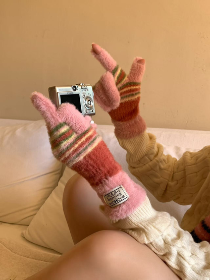 Pink fuzzy fingerless gloves with coral, cream and green stripes