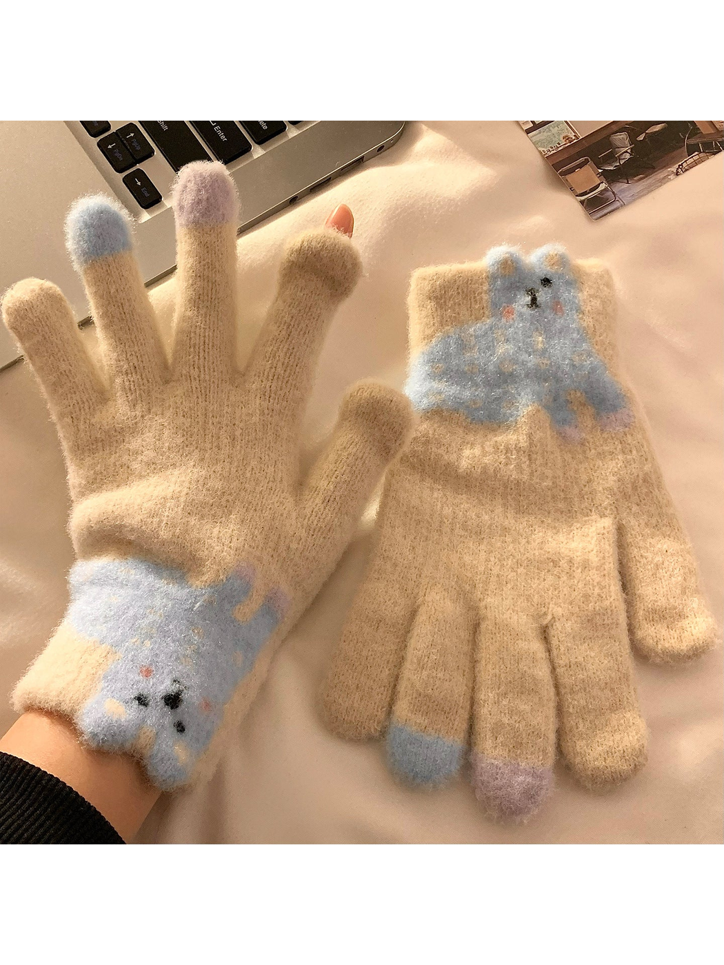 Beige fuzzy gloves with a blue long-eared character appliqué
