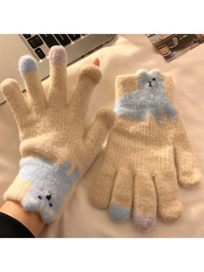 Beige fuzzy gloves with a blue long-eared character appliqué