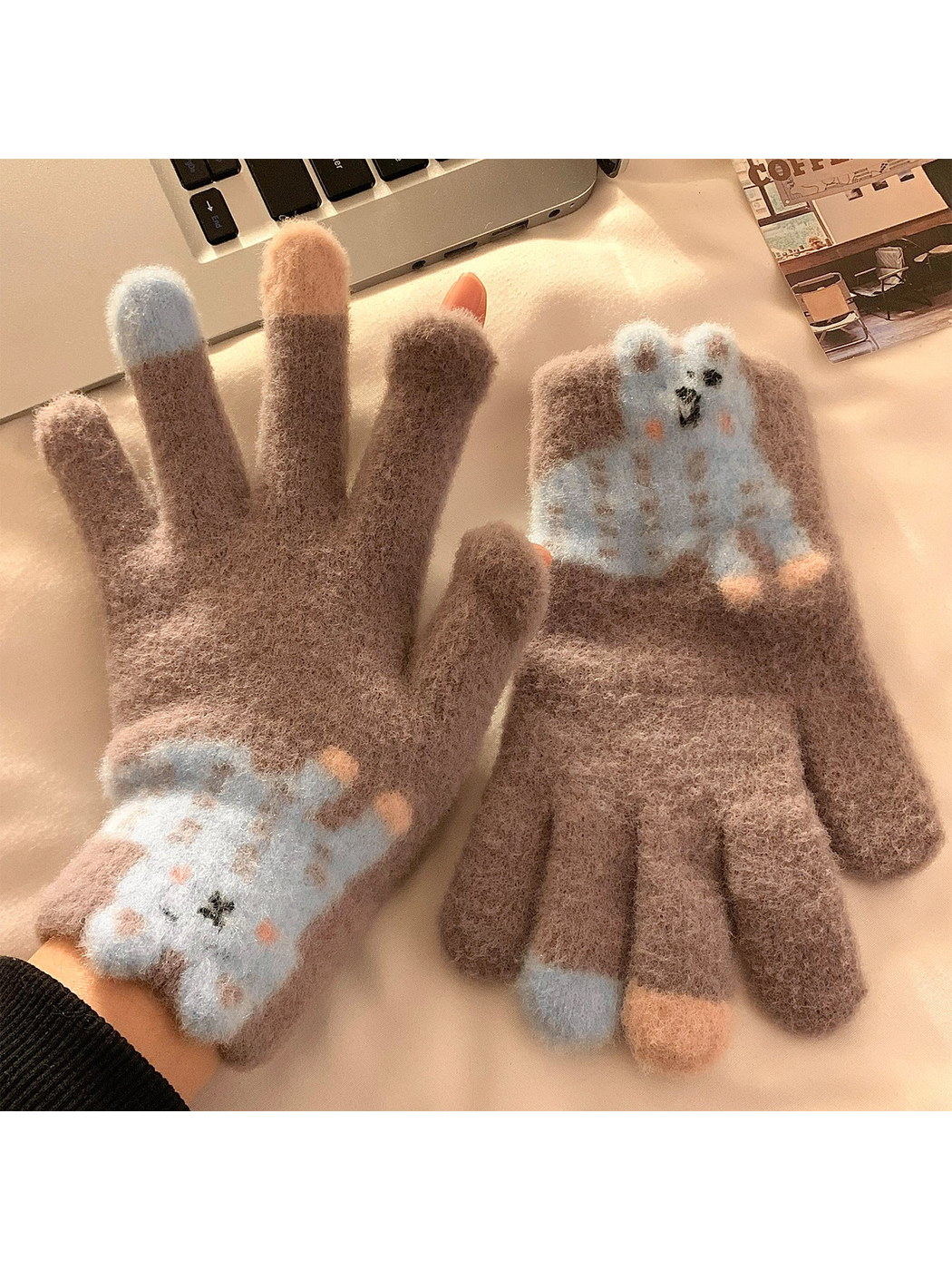 Greige fuzzy gloves with a blue spotted long-eared character appliqué
