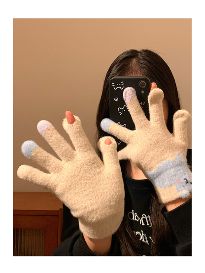 Beige fuzzy gloves worn with open fingertip slots visible