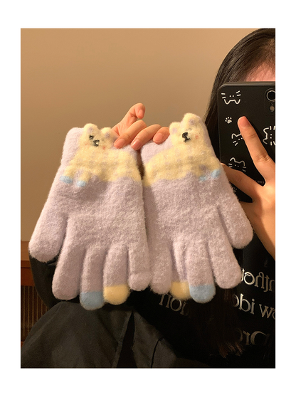 Pair of Light Purple fuzzy gloves held in front of a mirror