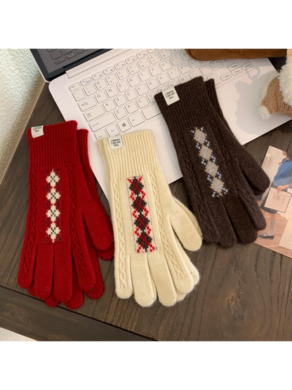Red, ivory and brown patterned gloves arranged on a tabletop