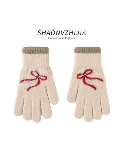 Beige gloves with red bow motifs and contrasting cuffs