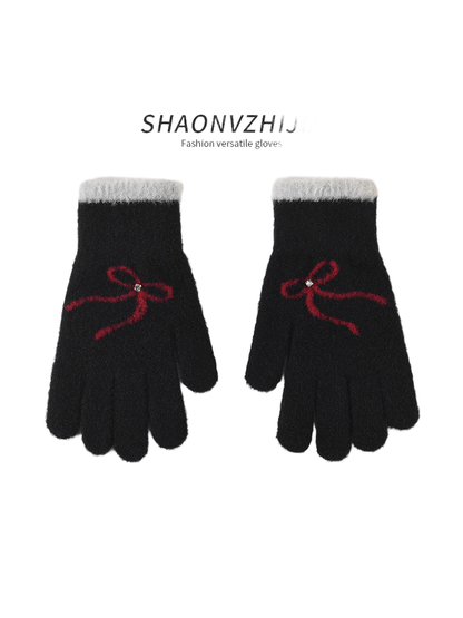 Black gloves with red bow motifs and contrasting cuffs