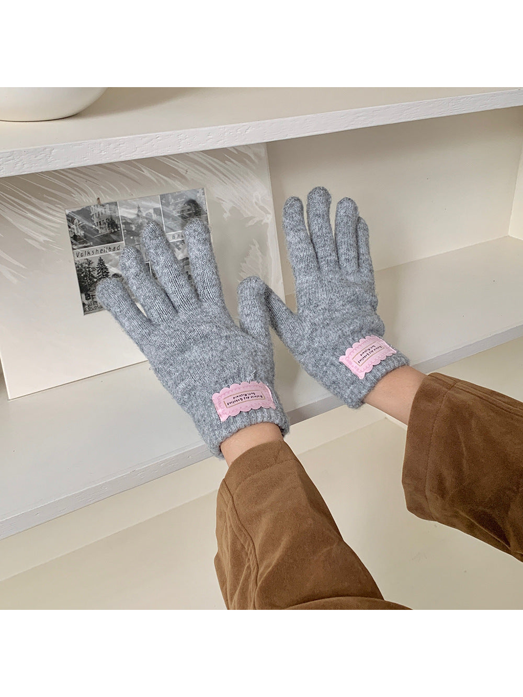 Heather Gray fuzzy knit gloves worn with a brown jacket