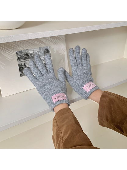 Heather Gray fuzzy knit gloves worn with a brown jacket