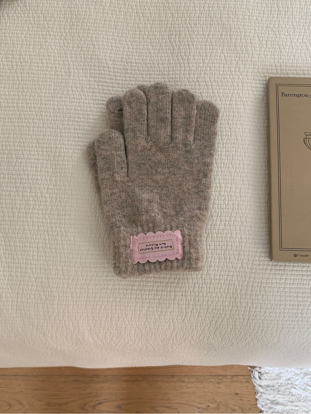 Greige fuzzy knit gloves with ribbed cuffs and pink labels