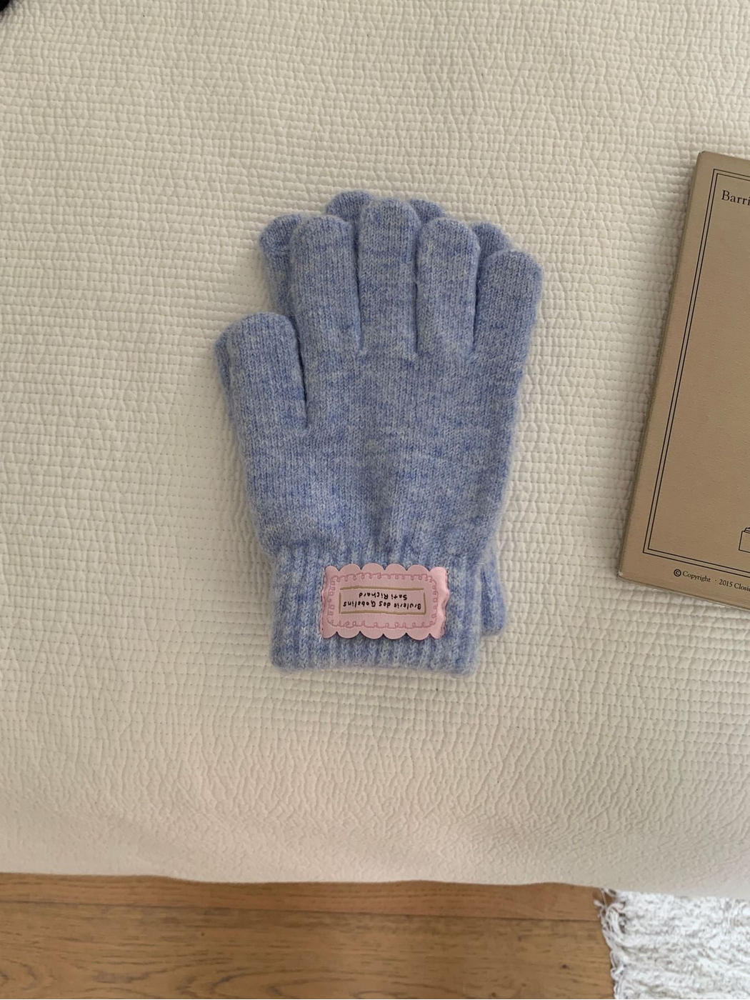 Light Blue fuzzy knit gloves with ribbed cuffs and pink labels