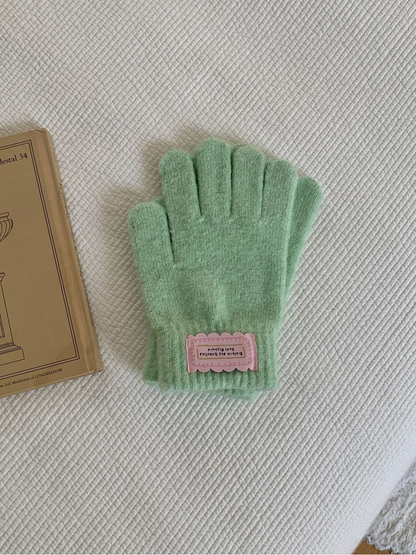 Mint fuzzy knit gloves with ribbed cuffs and pink labels
