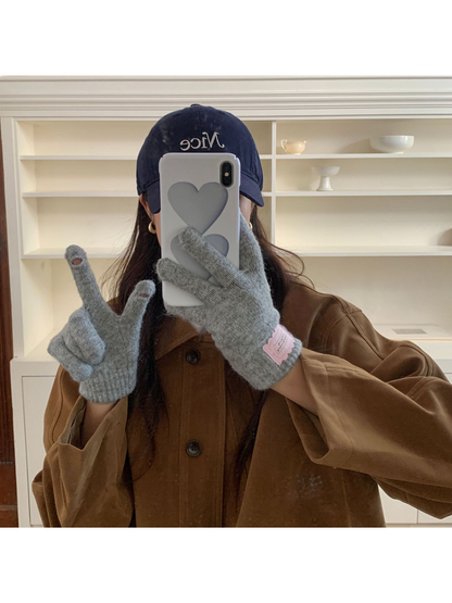 Heather Gray fuzzy knit gloves used with a smartphone
