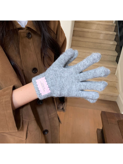 Close-up of the fuzzy texture and ribbed cuff on a Heather Gray glove