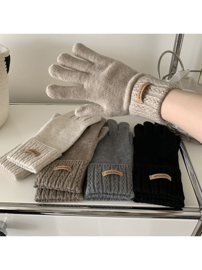 Ivory, beige, coffee, gray and black gloves displayed together