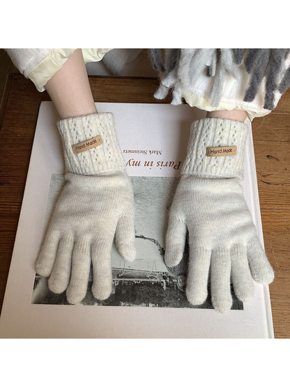 Ivory gloves with extended ribbed cuffs, worn palm view