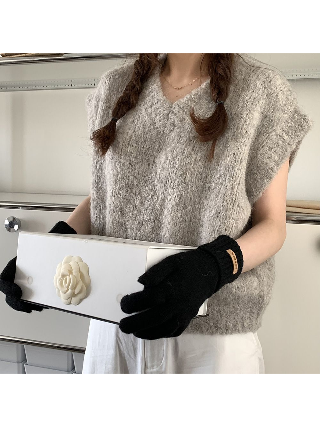 Black gloves styled with a gray textured top and white trousers