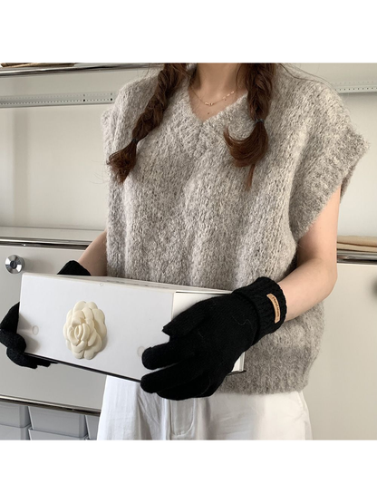 Black gloves styled with a gray textured top and white trousers