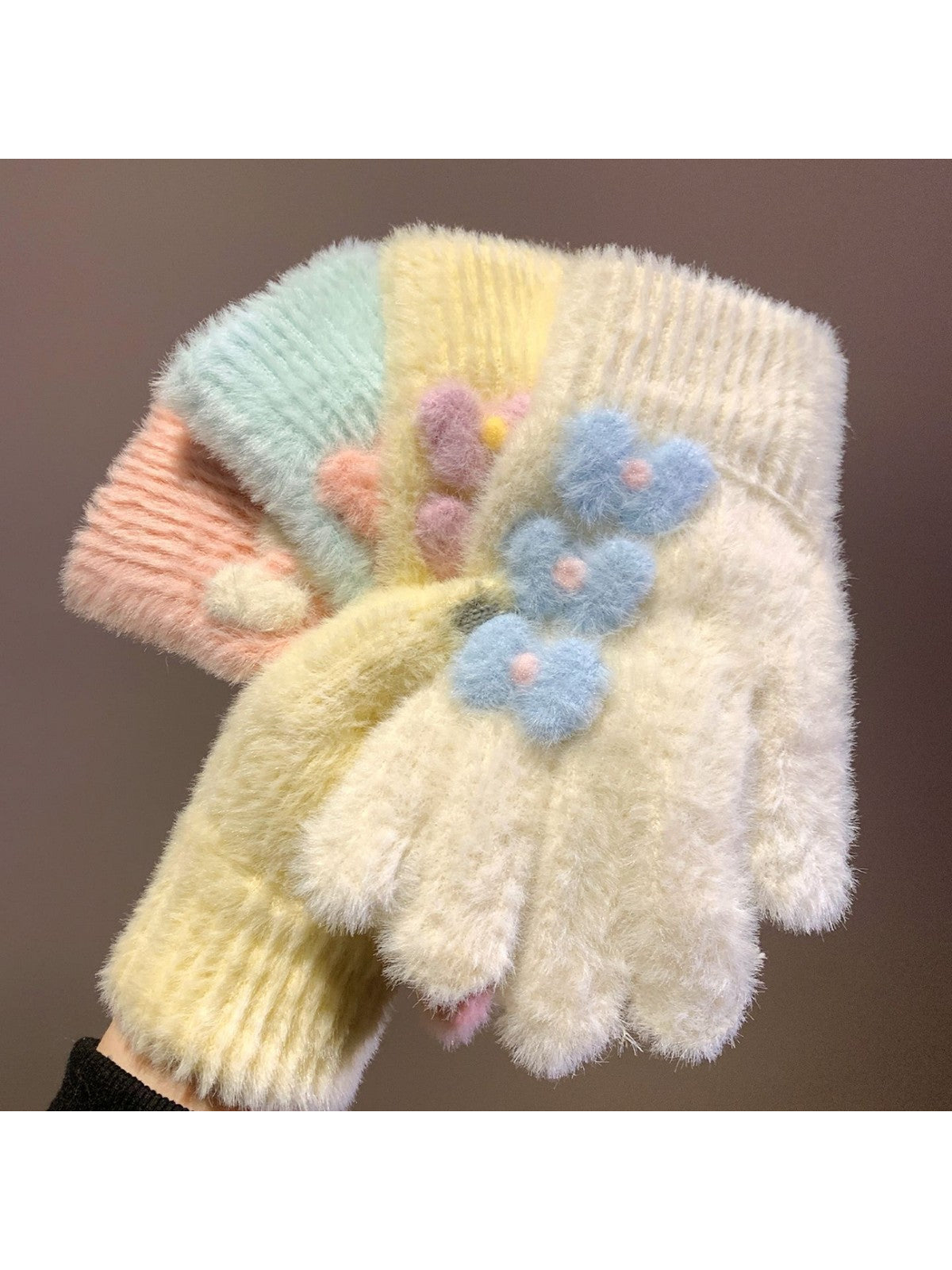 Yellow, ivory, light pink and light blue fuzzy gloves displayed together