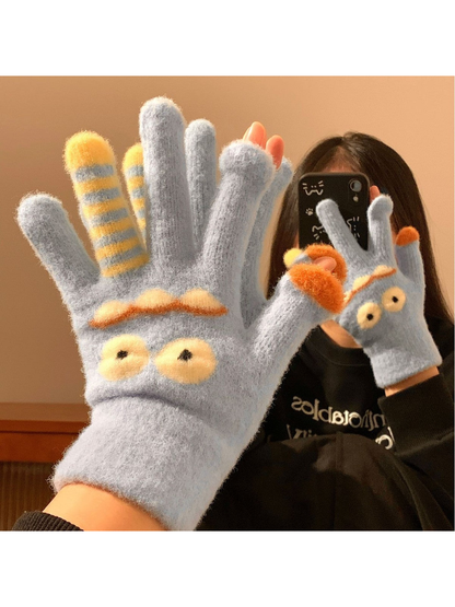 Light Blue cartoon monster gloves worn with the palms facing forward