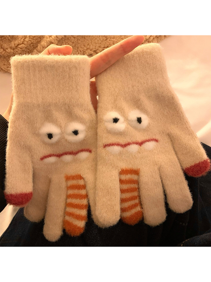 Beige cartoon monster gloves with raised eyes and striped finger accents