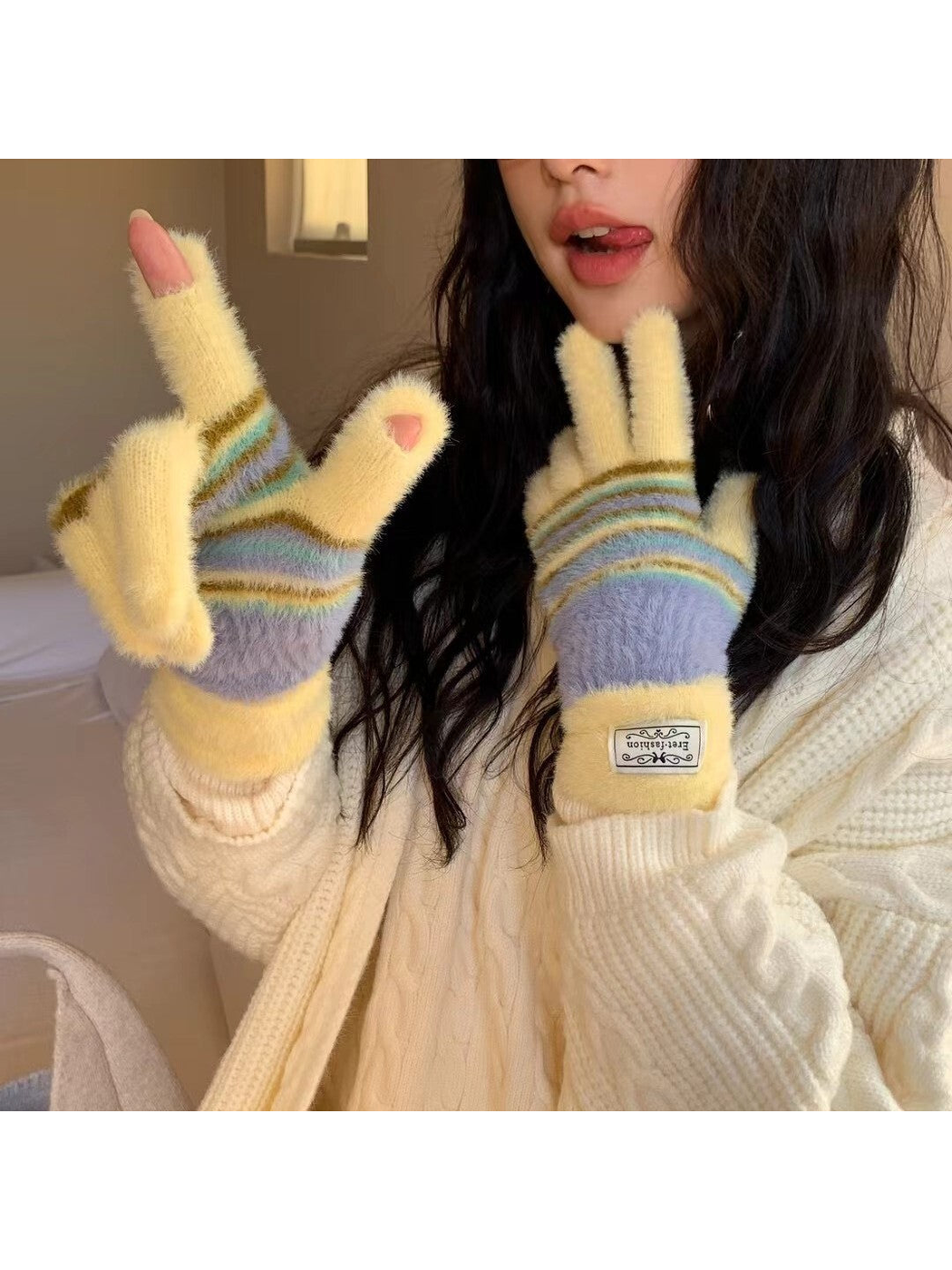 Yellow fuzzy striped gloves worn with fingertip openings visible