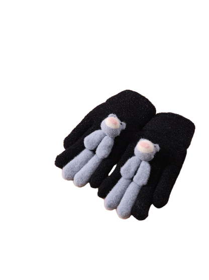 Black fuzzy gloves with gray teddy bear appliques, tabletop view