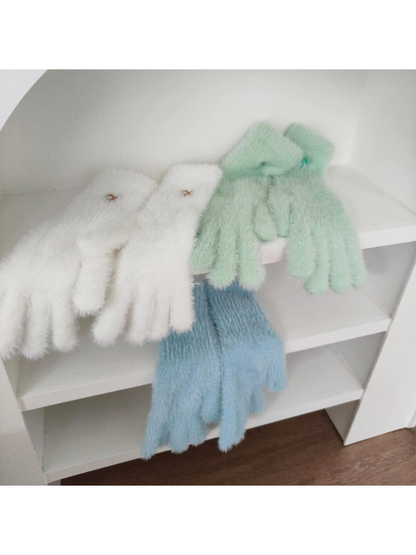 White, mint and light blue fuzzy gloves displayed together