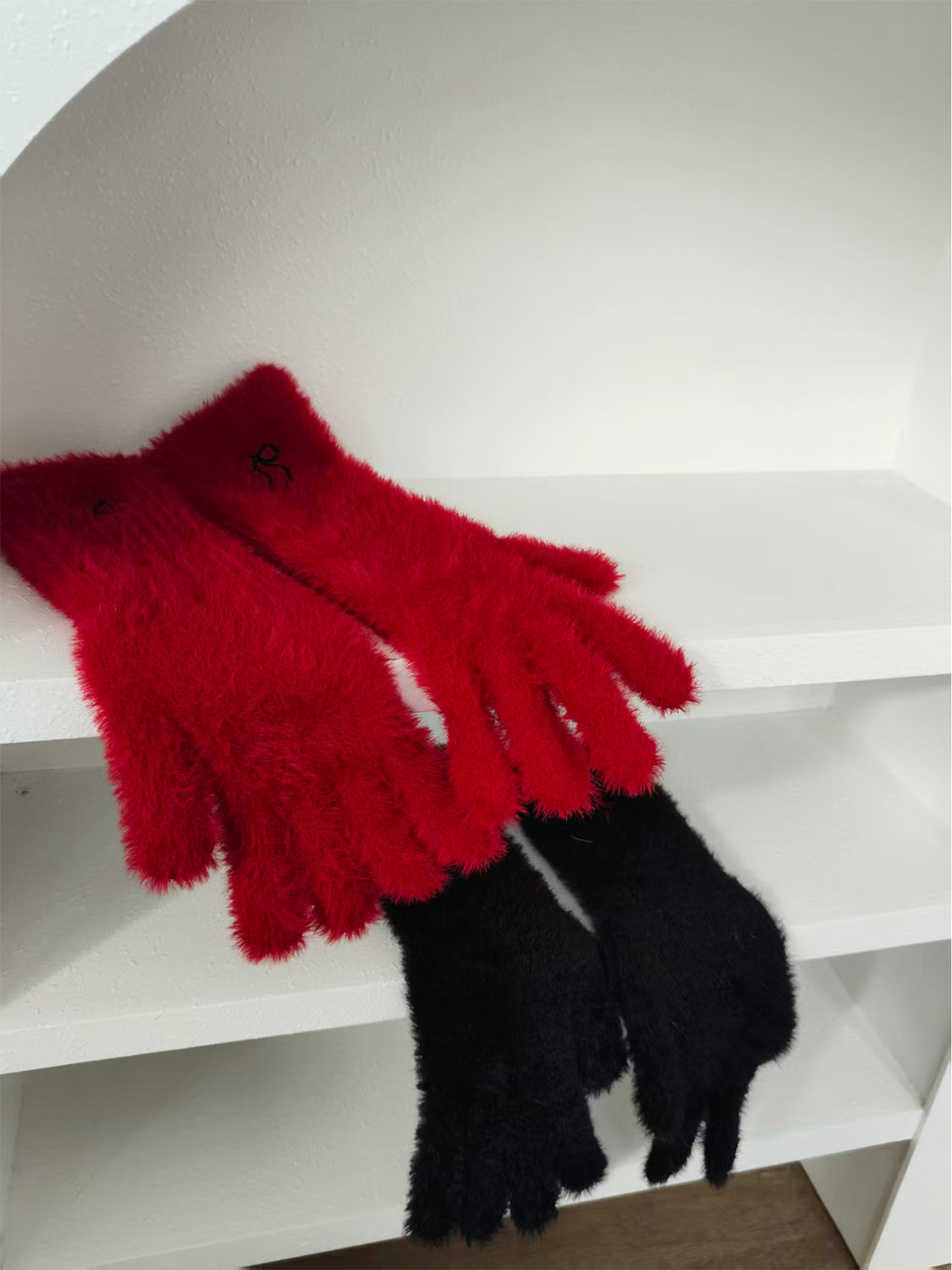 Red and black fuzzy gloves displayed together
