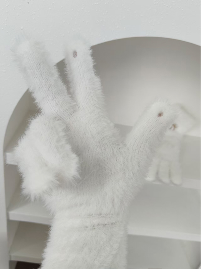 Close-up of white glove fingertip openings and fuzzy knit surface