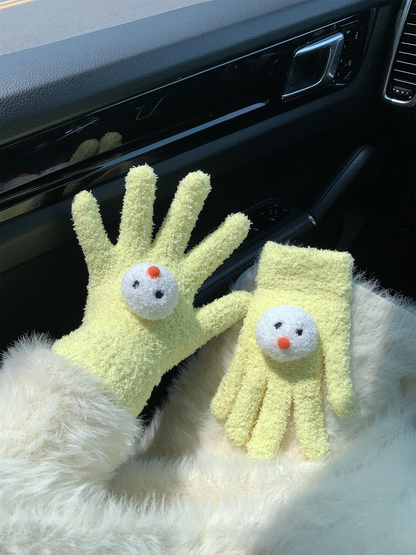 Yellow snowman-face gloves, one worn and one displayed flat