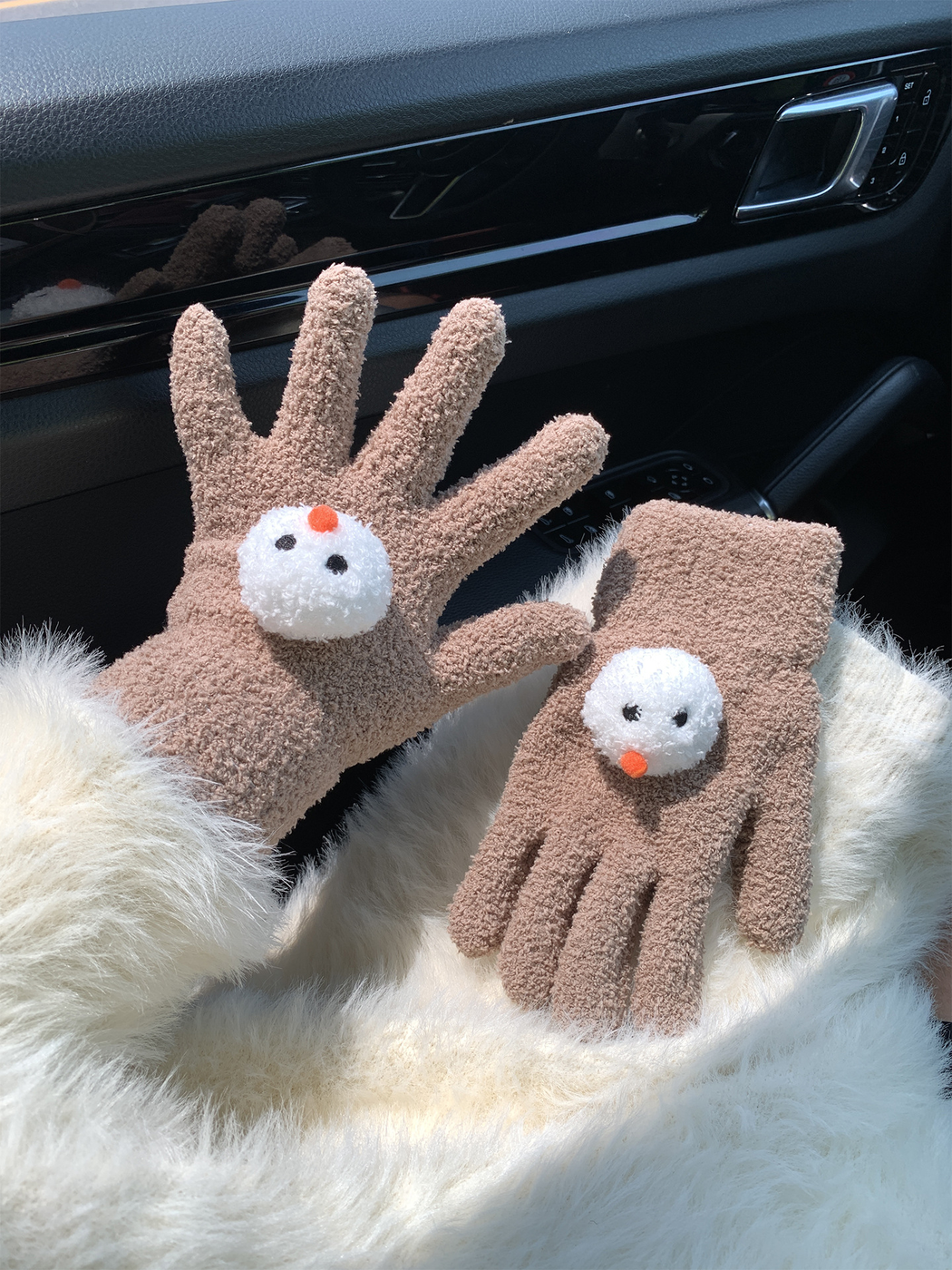 Coffee snowman-face gloves, one worn and one displayed flat