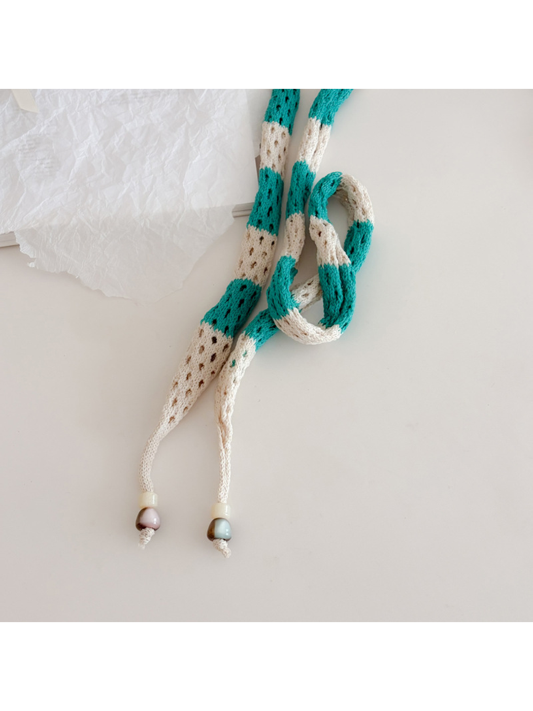 Close-up of the tapered scarf ends and tied openwork section