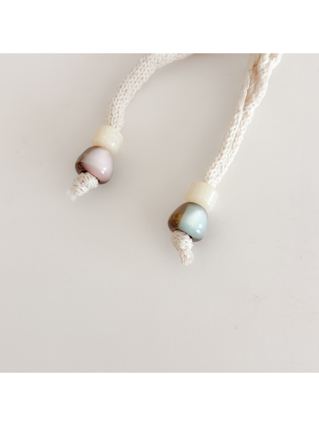 Close-up of the polished bead accents at the scarf ends