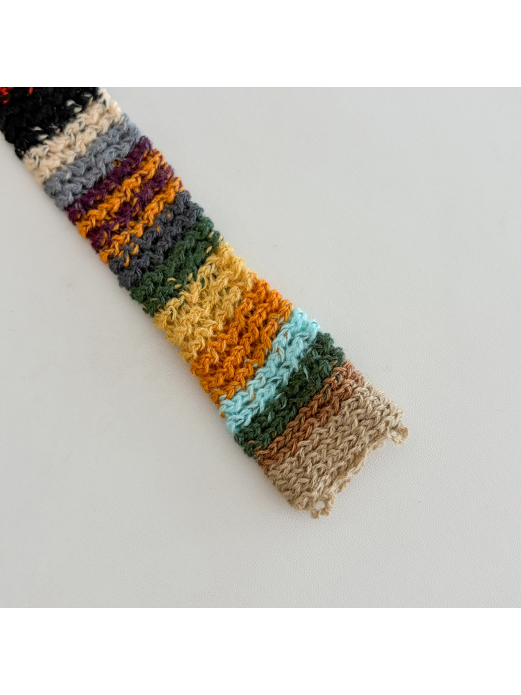 Close-up of the striped scarf end and short loose edge loops