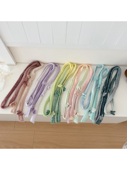Six gradient knit scarf colorways with butterfly appliqués displayed together