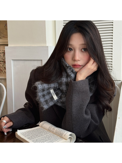 Black Gray checkered scarf worn indoors with a dark coat