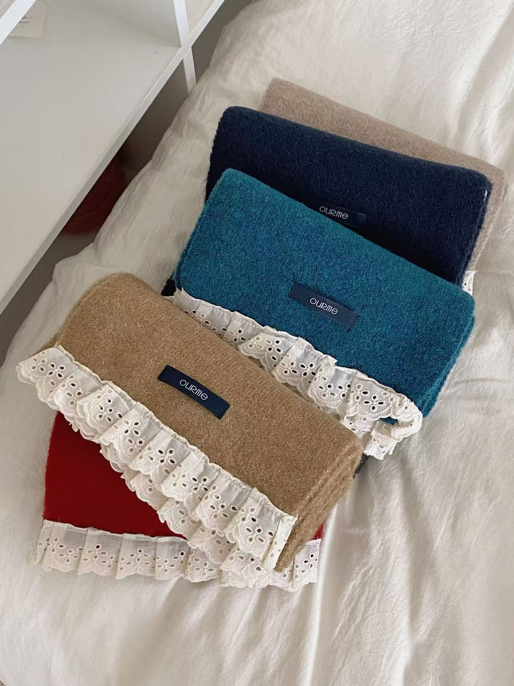 Five lace-trim scarf colors arranged in an overlapping stack