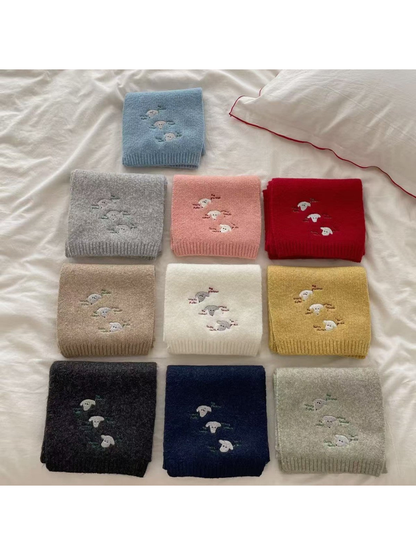 Embroidered knit scarves displayed together in multiple colors