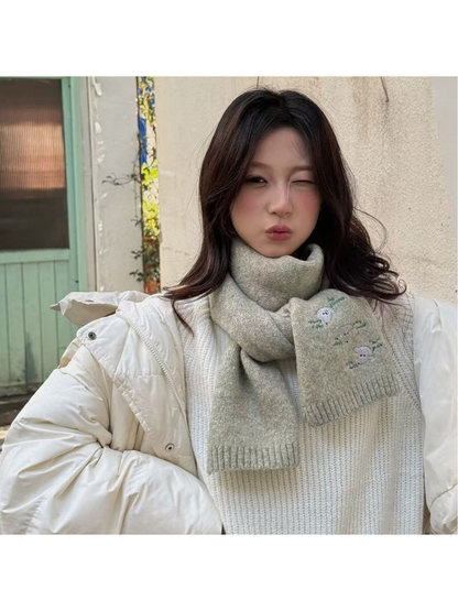 Light gray embroidered scarf styled with a white winter jacket
