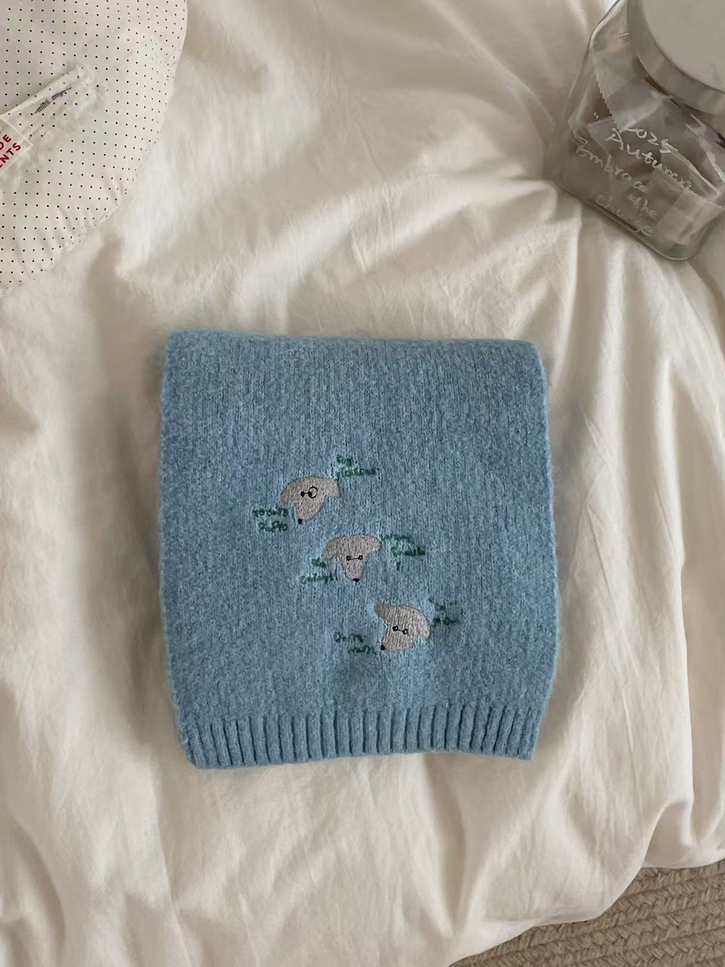 Light Blue knit scarf with embroidered dog faces and ribbed edging