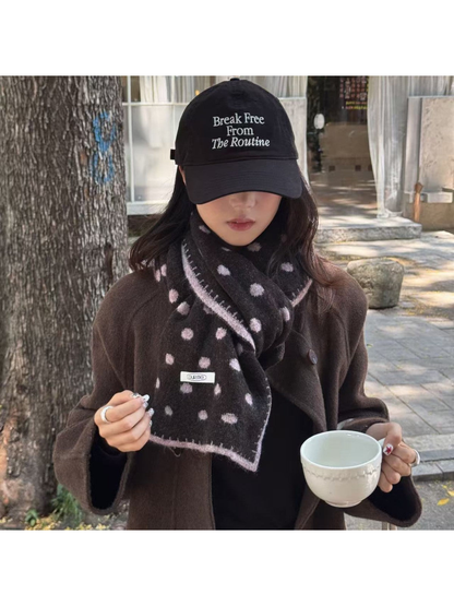 Brown Pink polka-dot scarf styled with a brown coat outdoors